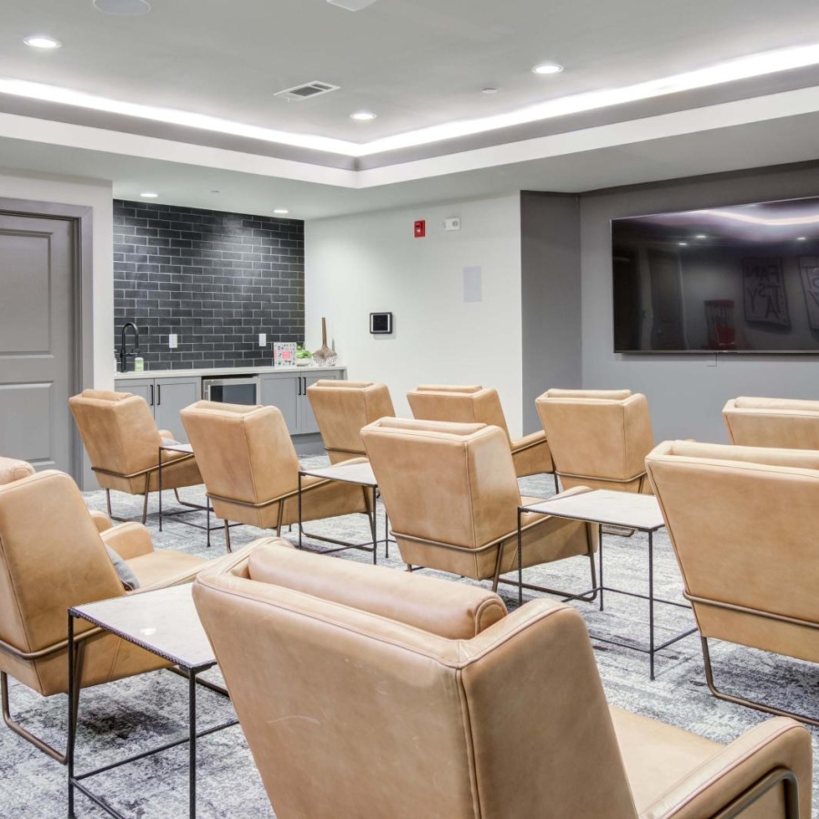 a room with chairs and a tv