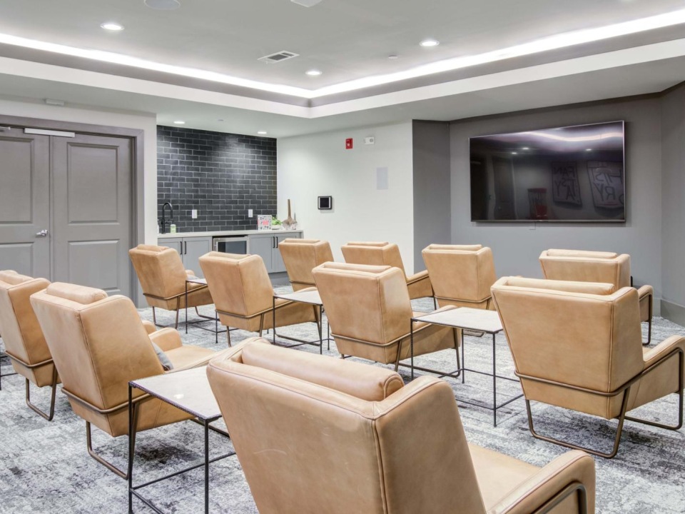 a room with chairs and a tv