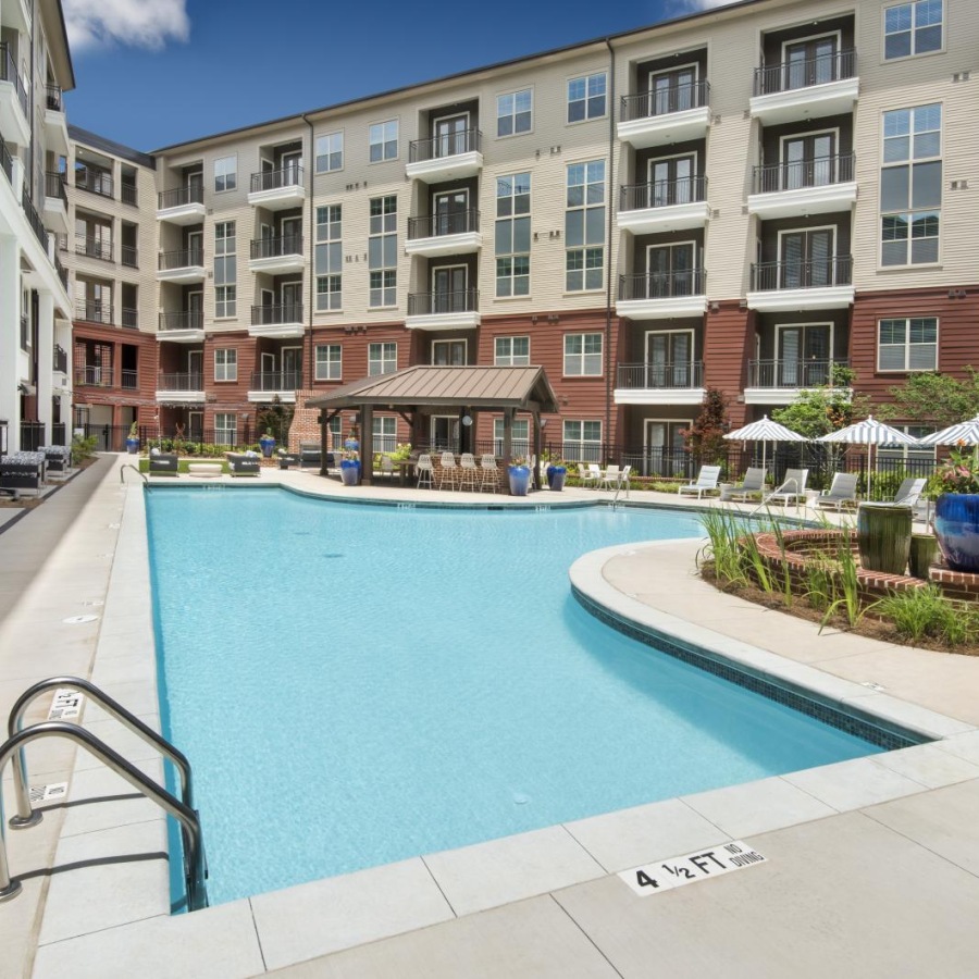 a swimming pool in a courtyard between buildings