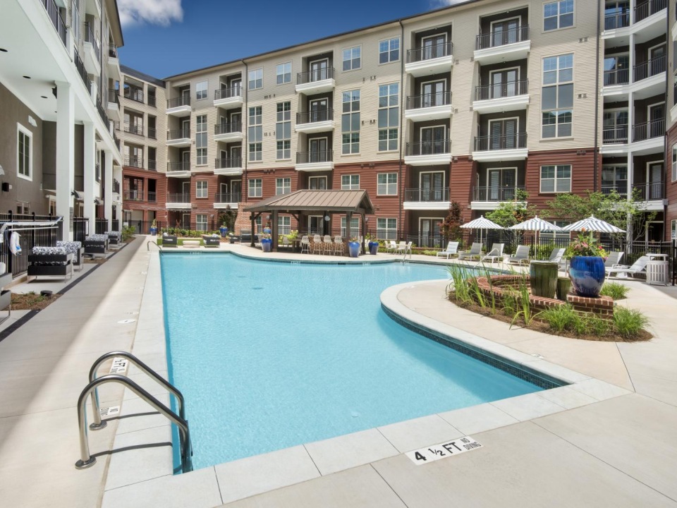 a swimming pool in a courtyard between buildings