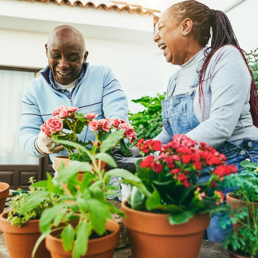 a man and a woman tending to flowers